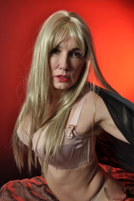 Hot mature blonde Nylon Jane wears a huge red strapon under sheer pantyhose