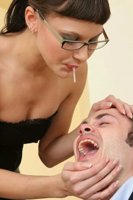 Dominant woman spits in a man's mouth before pegging him with a huge strapon