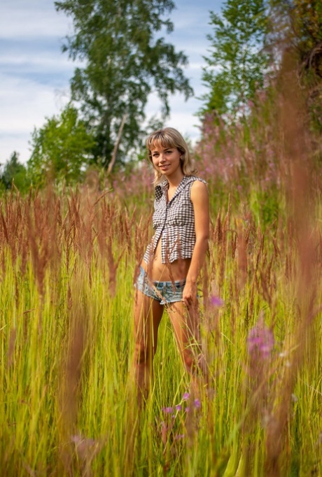 18-year-old blonde Nicole V gets totally naked against a sandy mound