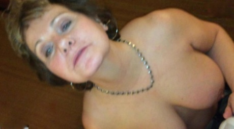 Mature lady Busty Bliss flashes her big tits before having her pussy licked