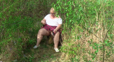 Fat British lady Lexie Cummings exposes herself on a bench in a field