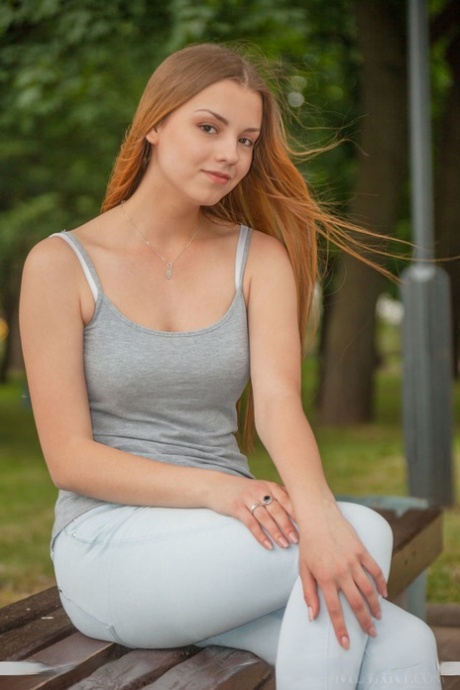 Redhead European babe undressing to bare tiny teen tits during glam shoot