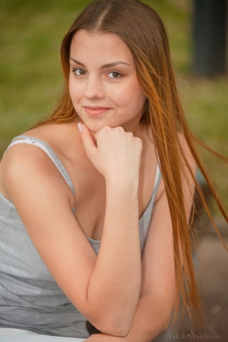 Redhead European babe undressing to bare tiny teen tits during glam shoot