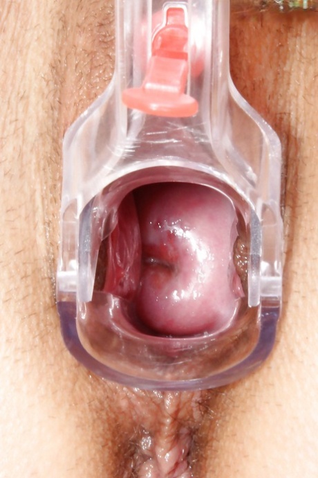 Busty gal in jeans undressing and stuffing her pink hole with gyno instruments