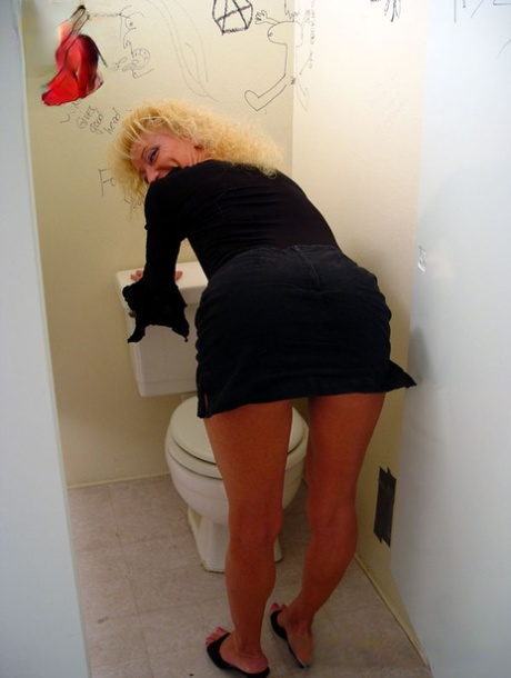 Blonde cougar wife gives a gloryhole blowjob while cuckold hubby fondles tits