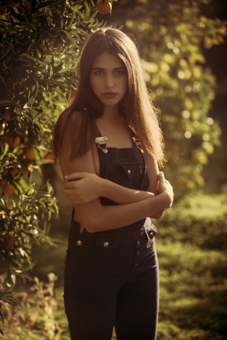 Cute international model Katrine Pirs flashes her natural tits in the garden