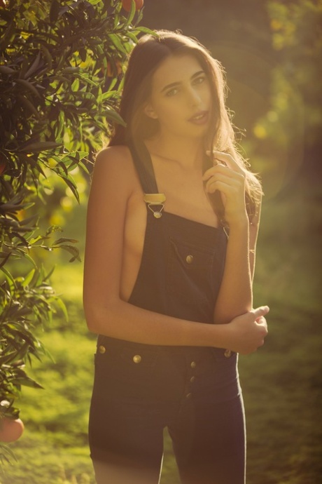 Cute international model Katrine Pirs flashes her natural tits in the garden