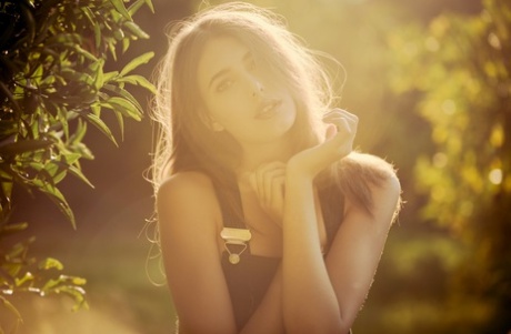 Cute international model Katrine Pirs flashes her natural tits in the garden