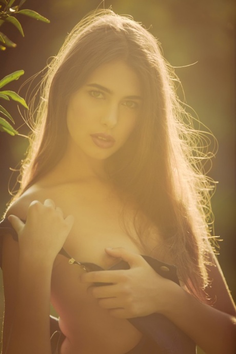 Cute international model Katrine Pirs flashes her natural tits in the garden