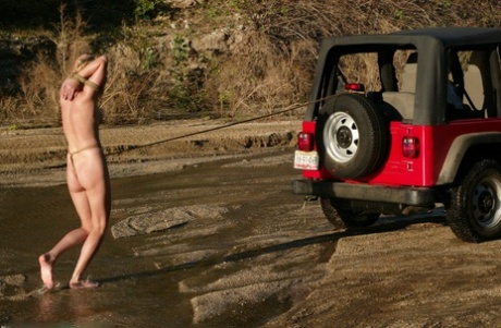 Submissive American walking butt naked tied to a Jeep on the beach