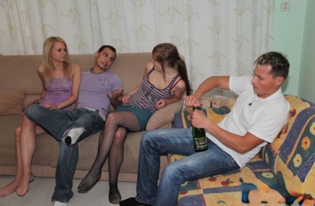 Sexy amateur teens with tiny tits share two stiff rods on a couch