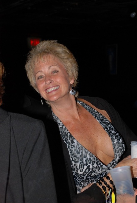 Mature swinger Tracy Lick reveals her big juggs and gets blacked at a club