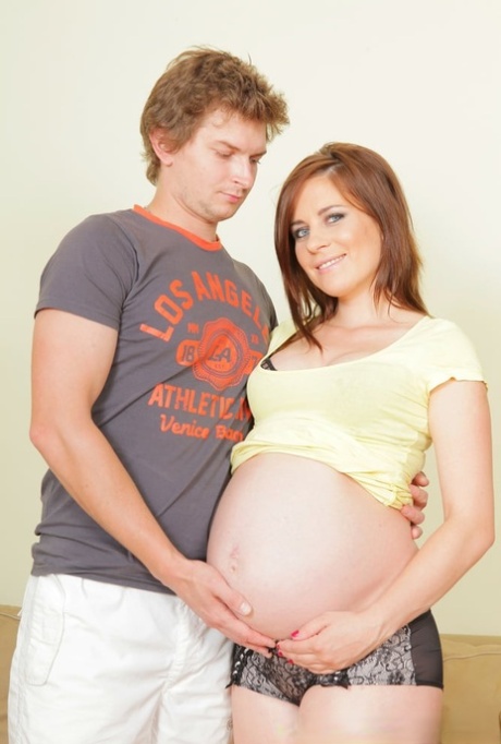 Pregnant babe undresses and gets nailed by her boyfriend on a couch
