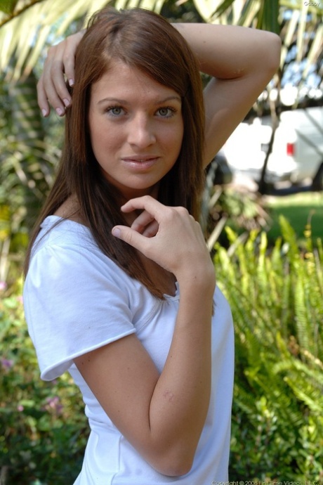 Blue eyed teen Gabby exposes her great juggs and poses with a toy in her cunt