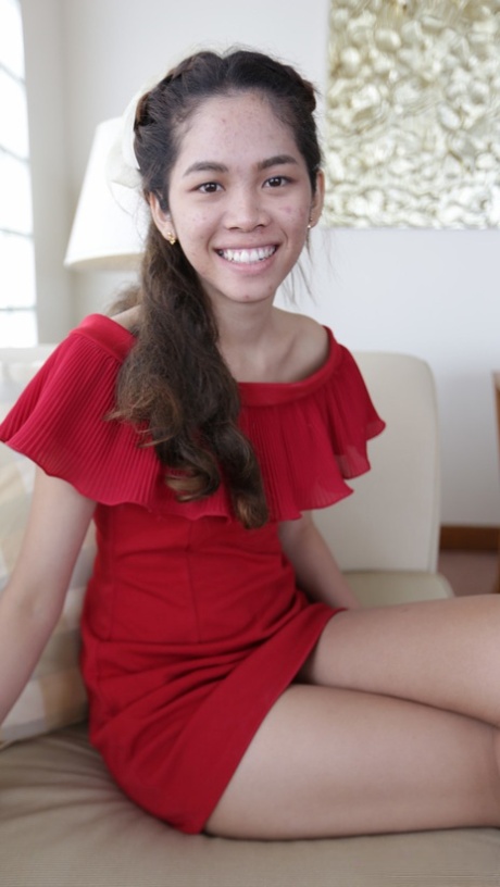 Beautiful Asian girl Mee shows off her hot legs in a short red dress