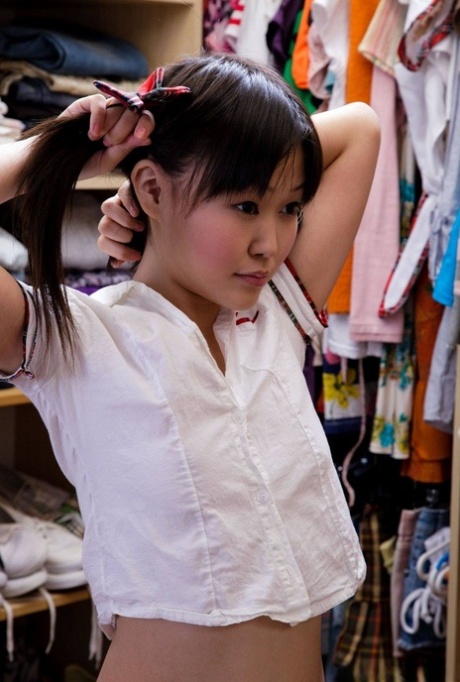 Sexy Asian schoolgirl Aliona toys her shaved pussy with a dildo