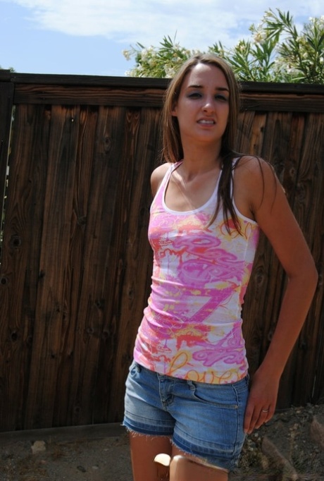 Sexy brunette amateur showing off her tiny boobs and big booty outdoors