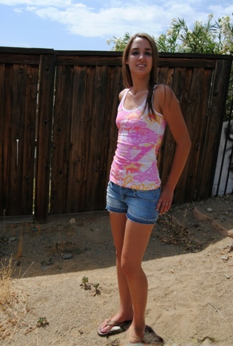 Sexy brunette amateur showing off her tiny boobs and big booty outdoors