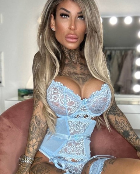 Glamorous tattooed model Jacky posing in her lace lingerie in a solo