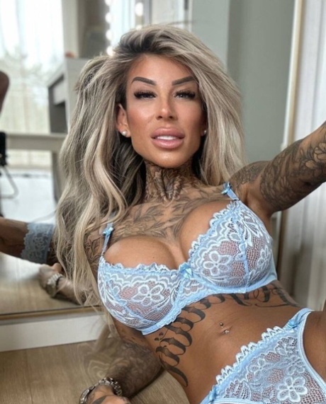 Glamorous tattooed model Jacky posing in her lace lingerie in a solo