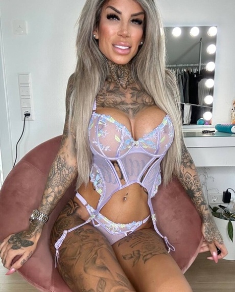 Glamorous tattooed model Jacky posing in her lace lingerie in a solo