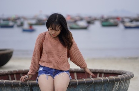 Stunning Asian babe poses in her jean shorts & sweater in public