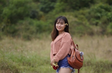 Stunning Asian babe poses in her jean shorts & sweater in public
