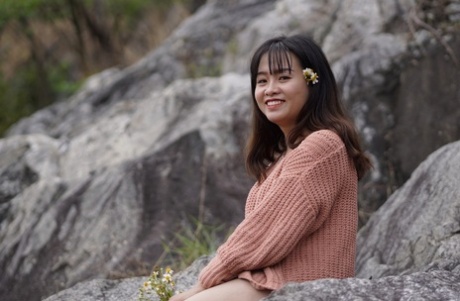 Stunning Asian babe poses in her jean shorts & sweater in public