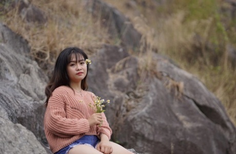 Stunning Asian babe poses in her jean shorts & sweater in public