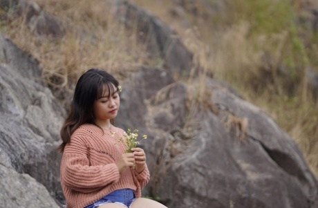 Stunning Asian babe poses in her jean shorts & sweater in public