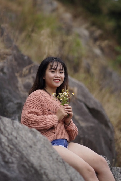 Stunning Asian babe poses in her jean shorts & sweater in public