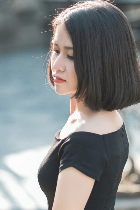 Glamorous Asian babe posing in her elegant black dress in public
