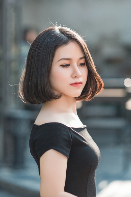 Glamorous Asian babe posing in her elegant black dress in public