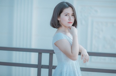 Glamorous Asian babe posing in her elegant black dress in public