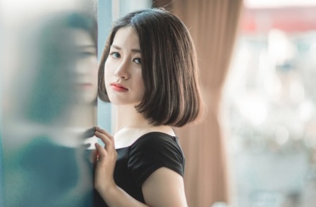 Glamorous Asian babe posing in her elegant black dress in public