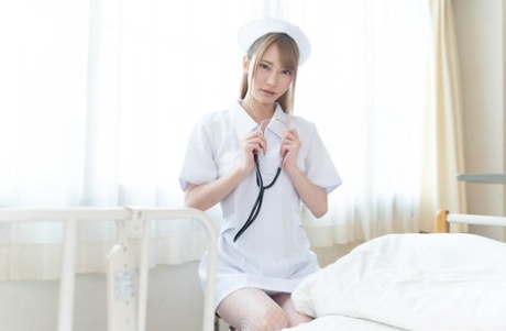 Slutty Asian nurse Yui Kisaragi lets a patient finger her pussy and fuck her