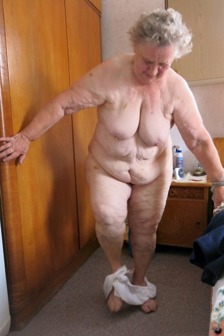 Old granny Advotia strips down naked and exposes her saggy tits & chubby body