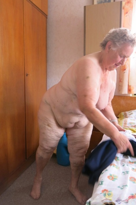 Old granny Advotia strips down naked and exposes her saggy tits & chubby body