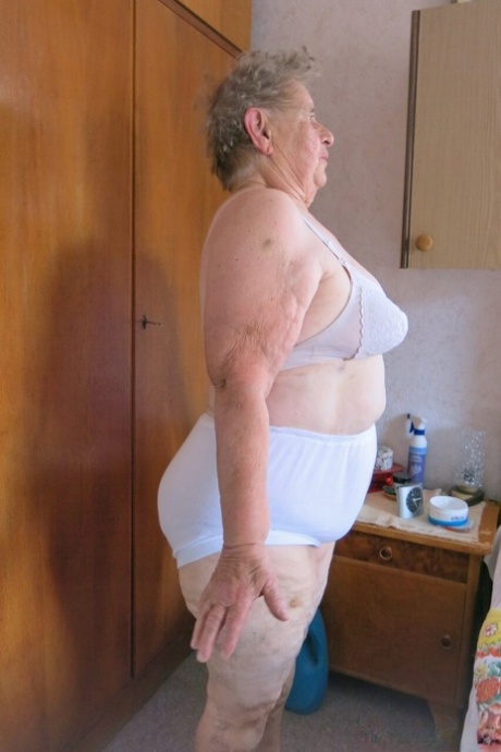 Old granny Advotia strips down naked and exposes her saggy tits & chubby body