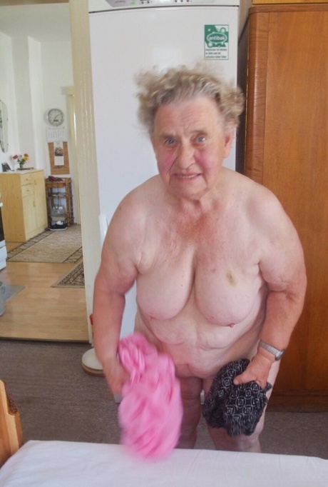 Old granny Advotia strips down naked and exposes her saggy tits & chubby body
